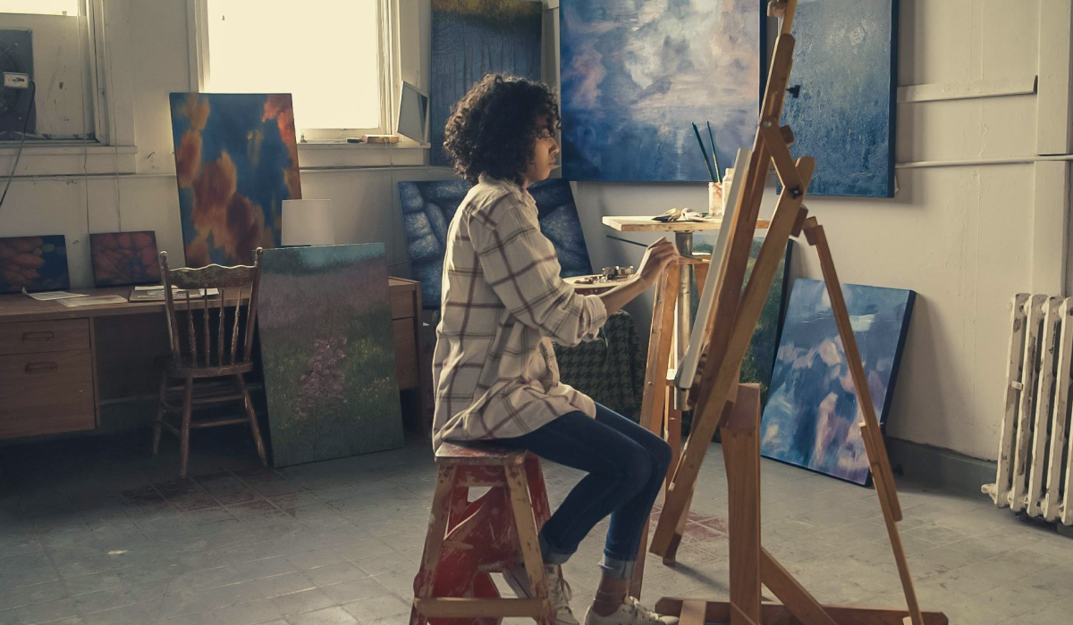 Woman painitng at easel 